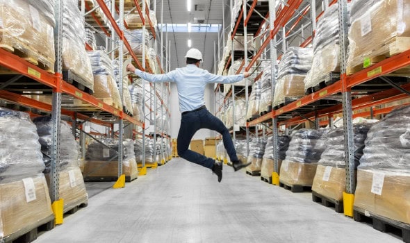Happy warehouse man jumping