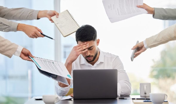 Many hands extending towards stressed man